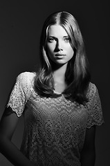 Image showing Black and white, fashion and portrait of woman on dark background with beauty, style and trendy clothes. Monochrome, aesthetic and face of serious person with confident, pride or attractive in studio