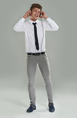Image showing Businessman, headphones and singing to music in studio, streaming radio and pop song on gray background. Male person, break and listening to hip hop playlist for fun, dancing and enjoying sound