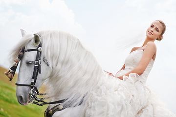 Image showing Wedding, woman and riding with horse or portrait outdoor with happiness for celebration, marriage and confidence. Bride, person and stallion on lawn in field with smile, dress and animal at ceremony