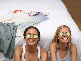 Image showing Women, spa and friends in bedroom, smile and self care on bed together. Sisters, cucumber and wellness connect for home, relaxation and beauty talk for happiness, skincare and antioxidant treatment