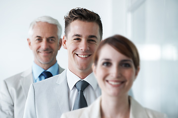 Image showing Smiling , friendly group of three businesspeople , and of different age private company staff posing for office portrait. Diverse business partners , team of colleagues professionals working office