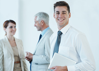 Image showing Portrait, smile and business man with tablet in office for start of corporate career as professional intern. Technology, trust and happy young employee in boardroom of workplace with colleagues