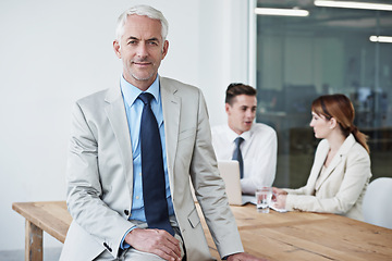 Image showing Smile, manager and portrait of businessman in office at meeting with team for corporate legal case. Happy, confident and senior male attorney ceo on table in workplace boardroom for law project.