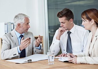 Image showing Business people, leader or planning on paperwork for collaboration, strategy or notes at office. Senior CEO, teamwork or employees with documents or report in meeting for brainstorming at workplace