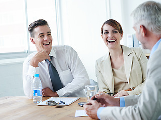 Image showing Teamwork, happy and business people laughing in a meeting for planning growth strategy ideas. Smile, humor and CEO speaking of a funny joke with group of employees, colleagues or workers in boardroom