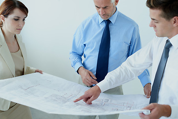 Image showing Blueprint, people or civil engineering team planning project, maintenance or renovation in meeting. Architecture, office building or group of designers with floor plan for property development ideas