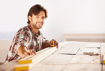 Image showing Carpenter, measuring tape and wood in workshop, smile and happiness for job, service and plan. Man, working and builder for furniture, professional and machine for craft, career and industry