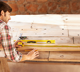 Image showing Handyman, marking and measuring tape on wood in workshop, home repairs and professional with plan. Person, working and handcraft with maintenance, job and career in industry, skill and technique