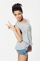 Image showing Portrait, woman and peace sign with tongue in studio for fun, playful and humour with confidence. Female person, emoji and face with gesture for pose, fashion or expression on white background