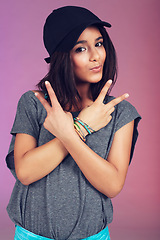 Image showing Studio, woman and portrait with cap, peace sign and clothes for happy, youth and hipster. Latino teen, fashion and pink background with bracelet, empowerment and confidence with trendy, cool and hat