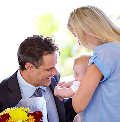 Image showing Coming home, flowers and parents with baby in a house with love, support and bonding with gratitude. Happy family, bouquet and business man with floral surprise for first mothers day celebration