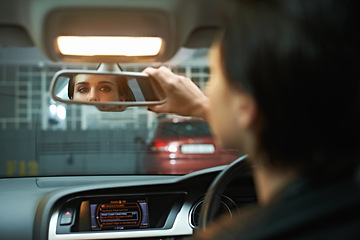 Image showing Woman, car and checking mirror in parking lot for observation, awareness or transportation. Female person or driver looking in rear view reflection for drive, reverse or interior check in vehicle