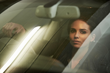 Image showing Woman, driver and look through windshield, portrait and car for transportation and night commute. Female, travel and vehicle pose for business, action and actress shot for commercial or movie scene