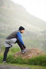 Image showing Nature, man and tie laces for run, fitness or morning workout with stretch in Cape Town. Male runner, thinking and preparing for warm up for health, exercise or athletics competition on mountain