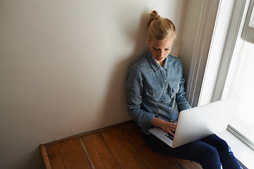 Image showing Woman, freelancer and laptop for blogging, remote work and internet connection on floor for info. Female person, editor and website for research or online news, writer and typing an article on tech