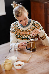 Image showing Woman, happy and herbal tea for calm in home and warm beverage of herbs mixture for health. Kitchen, person and detox with dry leaves in plunger and chamomile drink to relax in apartment in above