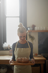 Image showing Bakery, kitchen and woman with bread on tray for cooking with healthy gluten free food for breakfast. Fresh, loaf and chef in restaurant with rye or sourdough for brunch, meal or lunch with nutrition