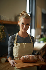 Image showing Bakery, kitchen and portrait of woman with bread on wood board and cooking gluten free food for breakfast. Fresh, loaf and chef in restaurant with healthy rye in preparation process of brunch