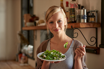 Image showing Portrait, woman and eating salad in kitchen at home, nutrition and fresh leafy greens for healthy diet. Vegetables, bowl and face of hungry person with food, fork and organic vegan meal for wellness