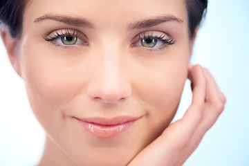 Image showing Skincare, facial beauty or portrait of woman in studio isolated on blue background for pride or wellness. Natural results, smile or smooth face of happy model or confident person with shine or glow