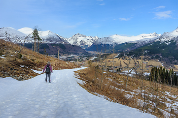 Image showing Lone hiker trekking on a snow-covered mountain path during winte