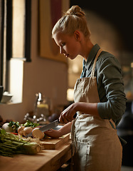 Image showing Cooking, woman and vegetables with knife in home with diet, nutrition and food with turnip. Kitchen, green and health from organic and vegan lunch with ingredients and wood board with wellness