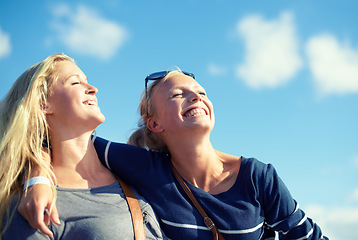 Image showing Girl, friends and happy hug with blue sky, fresh air and sunshine for mindfulness with peace. Woman, summer and outdoor to tour on vacation in Washington dc, happiness and laugh with bottom view