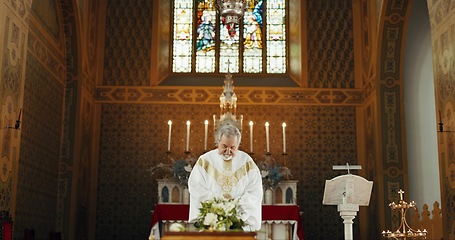 Image showing Funeral, church and priest with prayer by coffin for memorial service, sermon and ceremony for death. Religion, guidance and male pastor praying with congregation for comfort with casket in chapel