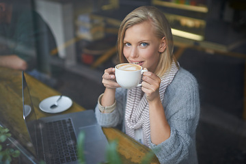 Image showing Coffee shop, laptop and portrait of woman with drink in window online for internet, website and research. Happy, relax and girl on computer for freelance career, remote work and email with cappuccino