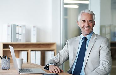 Image showing CEO, businessman and laptop at desk, portrait and work for lawyer firm. Senior executive, office and smile at company, suit and success in corporate workspace for attorney and insurance lawyers
