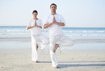 Image showing Couple, yoga and balance, meditation on beach for zen and wellness, travel and mindfulness with holistic healing. People outdoor, exercise and peace, workout together for bonding with sea and nature