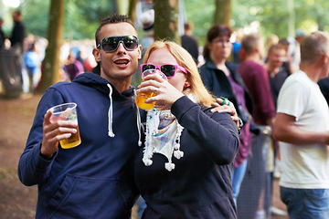 Image showing Drinks, happy and couple of friends at music festival, concert or party for outdoor rave or techno celebration. Portrait of young people, audience or crow in forest with beer or alcohol for holiday