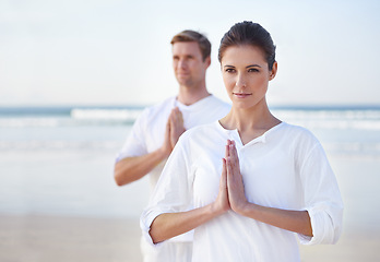 Image showing Prayer, yoga and couple on beach in morning for fitness, exercise and mindfulness in lotus pose. Nature, love and man and woman by ocean for meditation, wellness and healthy body outdoors together