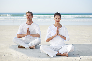 Image showing Lotus, yoga and couple on beach in morning for fitness, exercise and mindfulness with prayer hands. Nature, love and man and woman by ocean for meditation, wellness and healthy body outdoors together