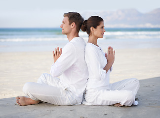 Image showing Couple, yoga and beach with meditation, sitting and peace on sand in morning with mindfulness in summer. Man, woman and outdoor for namaste with spiritual growth, balance or zen by ocean in Cape Town