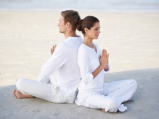 Image showing Couple, yoga and beach with peace, sitting and meditation on sand in morning with mindfulness in summer. Man, woman and outdoor for namaste with spiritual growth, balance or zen by ocean in Cape Town