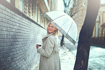 Image showing Woman, umbrella and coffee in street with portrait, smile and walking for commute in winter in city. Person, trench coat and outdoor for fashion on metro road with coco, tea cup or happy in Cape Town