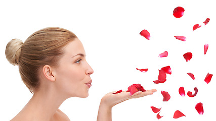 Image showing Woman, studio and blow with rose petals in profile for natural beauty, skincare or wellness by white background. Girl, model or person with flowers for celebration, organic confetti or Valentines Day