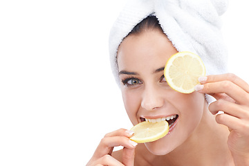 Image showing Woman, skincare and lemon in studio portrait for beauty, cosmetics and natural health or vitamin c benefits. Face of a young model eating fruits with eye dermatology or detox on a white background