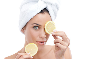 Image showing Woman, skincare and lemon in studio for facial beauty, cosmetics and natural product or vitamin c in portrait. Face of a young model with fruits for eye dermatology with towel on a white background