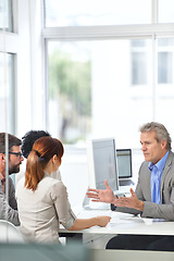 Image showing Senior businessman, meeting and coaching with team in data analytics, finance or discussion at office. Man, CEO or executive talking to group of employees for financial growth or revenue at workplace