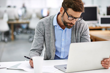 Image showing Businessman, laptop and writing with documents in finance, budget planning or investments at office. Man, accountant or employee with paperwork and computer for financial plan, growth or checklist