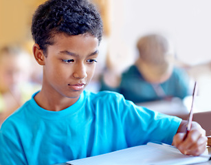 Image showing Student, boy and writing notes for knowledge in classroom, book and problem solving at school. Male person, child and study information for exam prep in notebook, solution and journal for assessment