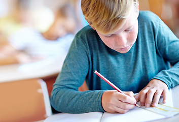 Image showing Student, boy and drawing for learning in classroom, book and problem solving at school. Male person, child and study information for exam prep in notebook, math solution and ruler for assessment