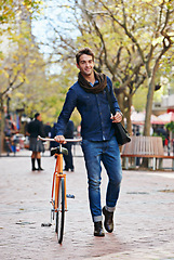 Image showing Man, walk and push bike in city to travel on eco friendly transport outdoor, commute or trip. Cycling, happy person or bicycle in urban town, street or road for journey at sidewalk of park with bag