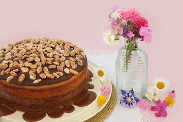 Image showing Homemade Peanut and Caramel Sauce Cake with Summer Flora