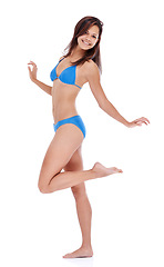 Image showing Woman, bikini and happy for studio portrait with pride, confidence or smile by white background. Girl, person and fashion model with blue clothes in summer with swimsuit on holiday for style in Italy