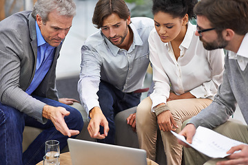 Image showing Business people, laptop and meeting with team for planning, strategy or brainstorming at office. Group of employees on computer with documents for discussion, research and development at workplace