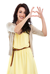 Image showing Woman, portrait and heart hands for thank you in studio, kindness and peace emoji or symbol. Happy female person, support icon and smiling on white background, romance emoticon and gratitude for care