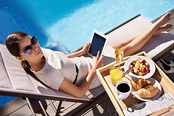 Image showing Hotel, pool and woman with breakfast, tablet and relax on business trip for food or drink service. Travel, hospitality and businesswoman on lounge chair at brunch with summer, luxury or villa holiday